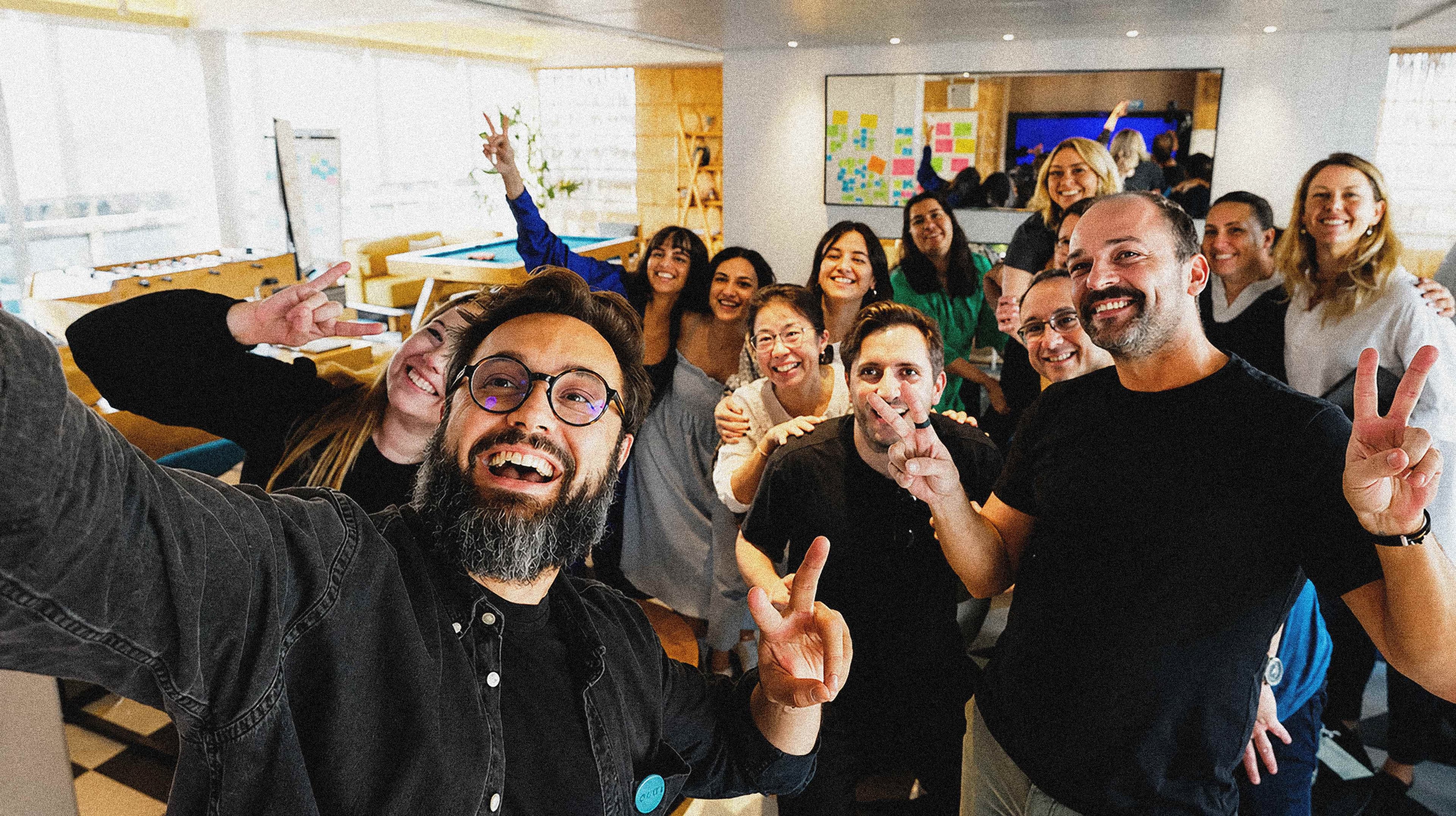 The REBORRN team throwing up peace signs during a company session