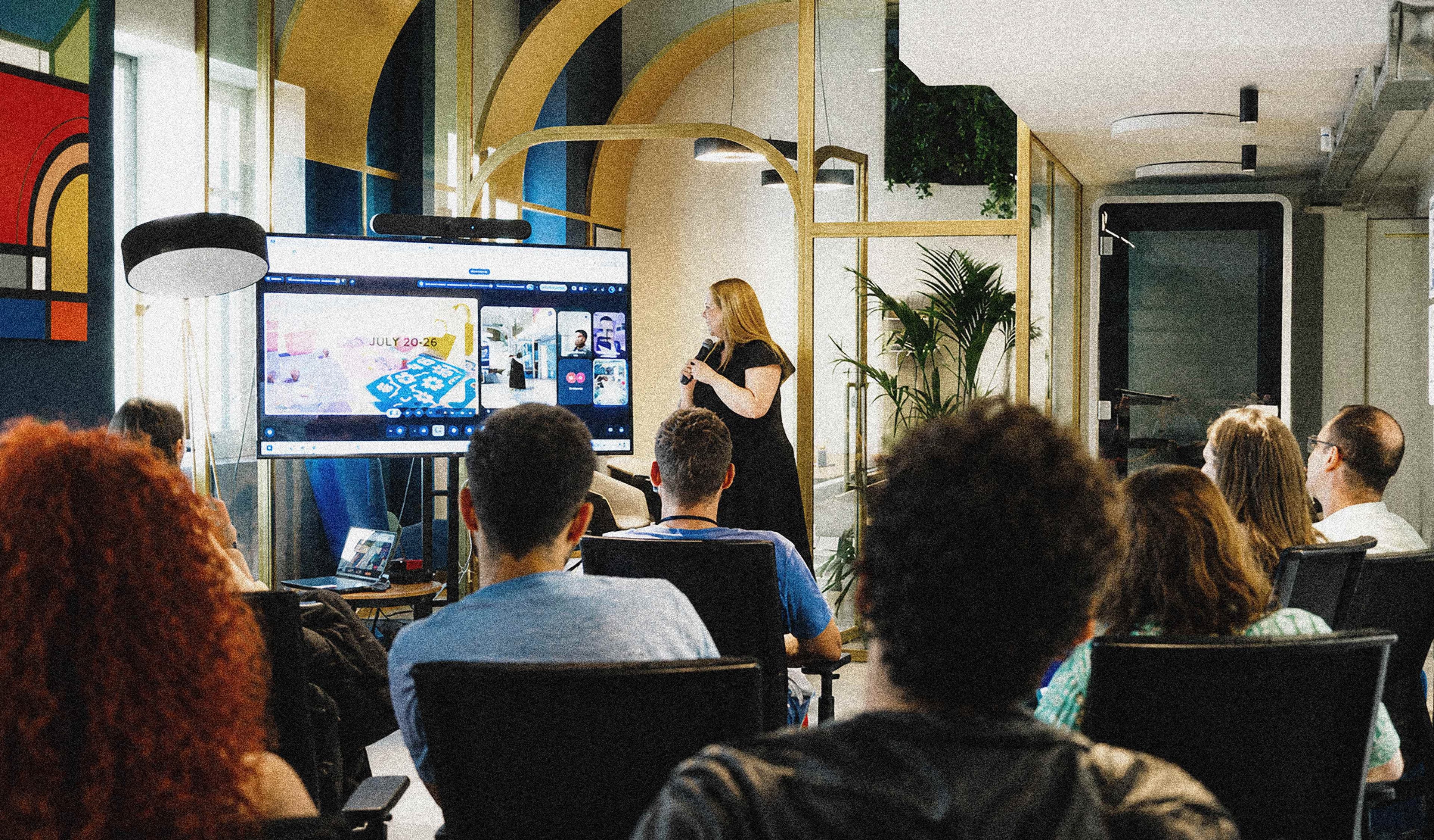 The team watching a presentation in the studio